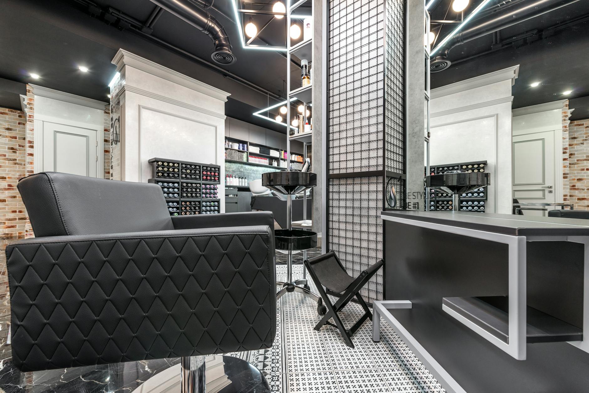 Contemporary and sophisticated barber shop interior with stylish furniture and lighting.